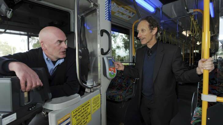 University of Sydney academic, Professor Adrian Bauman, right, talks with Action bus driver, Derek.? Photo: Graham Tidy