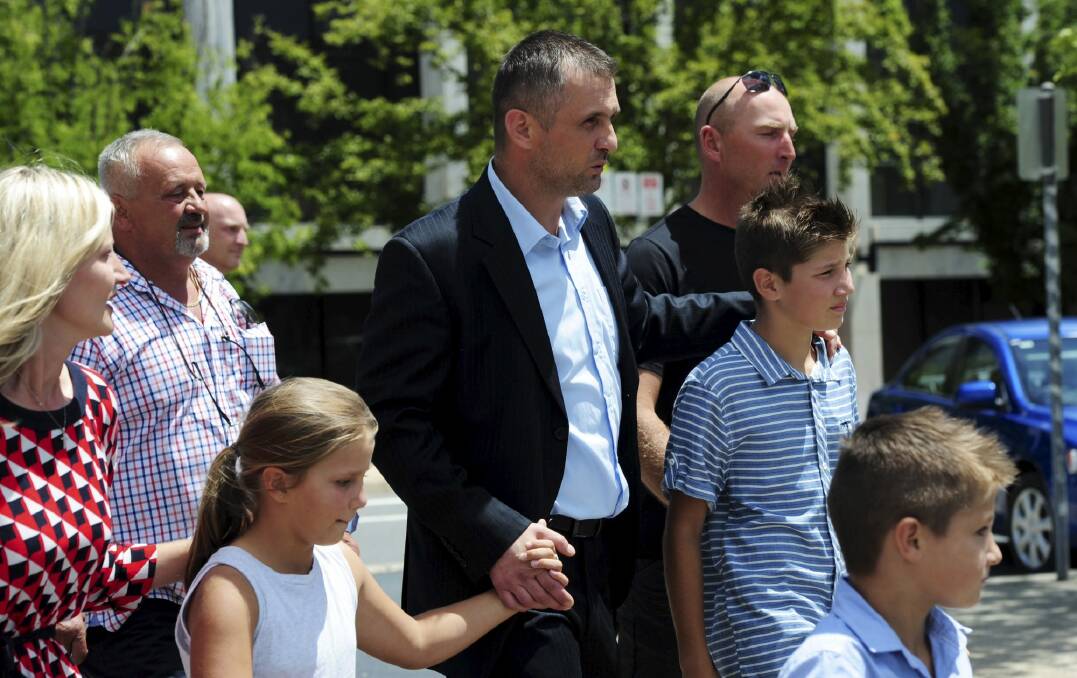 Free: Krunoslav Bonic walks from the
ACT Magistrates Court, surrounded by family and supporters. Photo: Graham Tidy