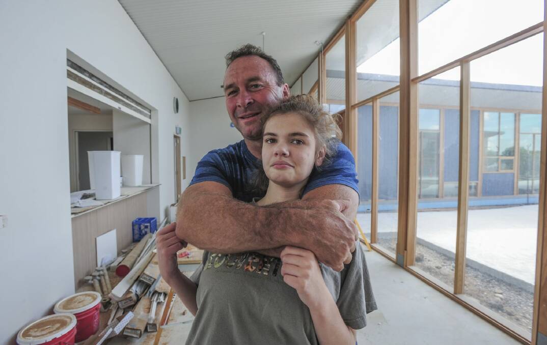 Canberra Raiders coach Ricky Stuart, pictured with his 18-year-old autistic daughter Emma at his respite house, wants Pauline Hanson to give disabled children a "fair go". Photo: Graham Tidy