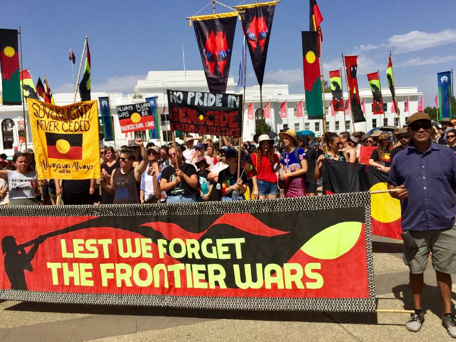 Invasion Day protesters arrive at the Aboriginal Tent Embassy opposite Old Parliament House on Saturday. Photo: Blake Foden