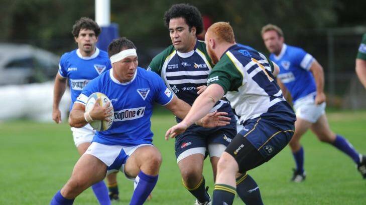 Royals hooker Robbie Abel (left) takes on Uni-Norths Owls defenders Richard Taumoepeau and Scott Meakins at ANU North Oval on Saturday. Abel is contracted to the Western Force. Photo: Graham Tidy