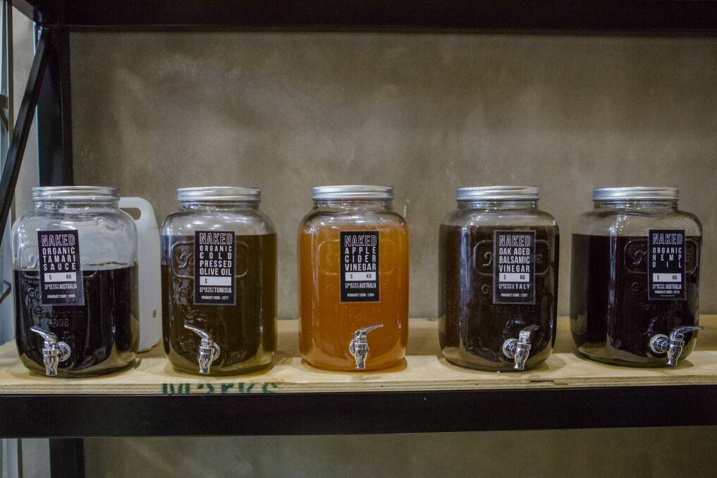 Oils and liquid syrups lined up on the shelves at Naked Foods. Photo: Jamila Toderas