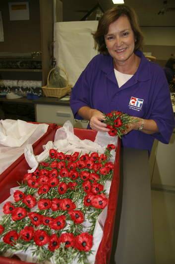 CIT floristry student Anne Docker packs the boutonnieres for cold storage until Anzac Day. Photo: Supplied