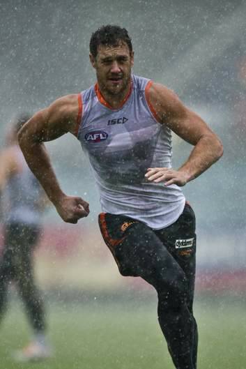 Shane Mumford trains in the rain at Manuka Oval on Wednesday. Photo: Jay Cronan