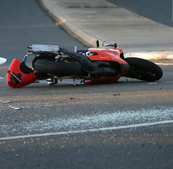 The scene following a crash that left a motorcyclist in a critical condition at the intersection of Southern Cross Drive and Ratcliffe Cresent. Photo: Jeffrey Chan