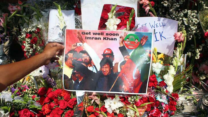 Flower and get-well messages for Imran Khan are placed outside the hospital in Lahore. Photo: AFP