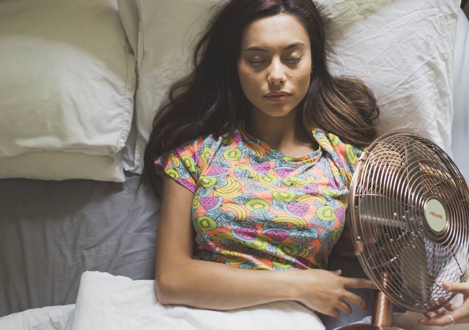 Journalist Serena Coady demonstrates the real way to sleep with a fan. Photo: Jamila Toderas