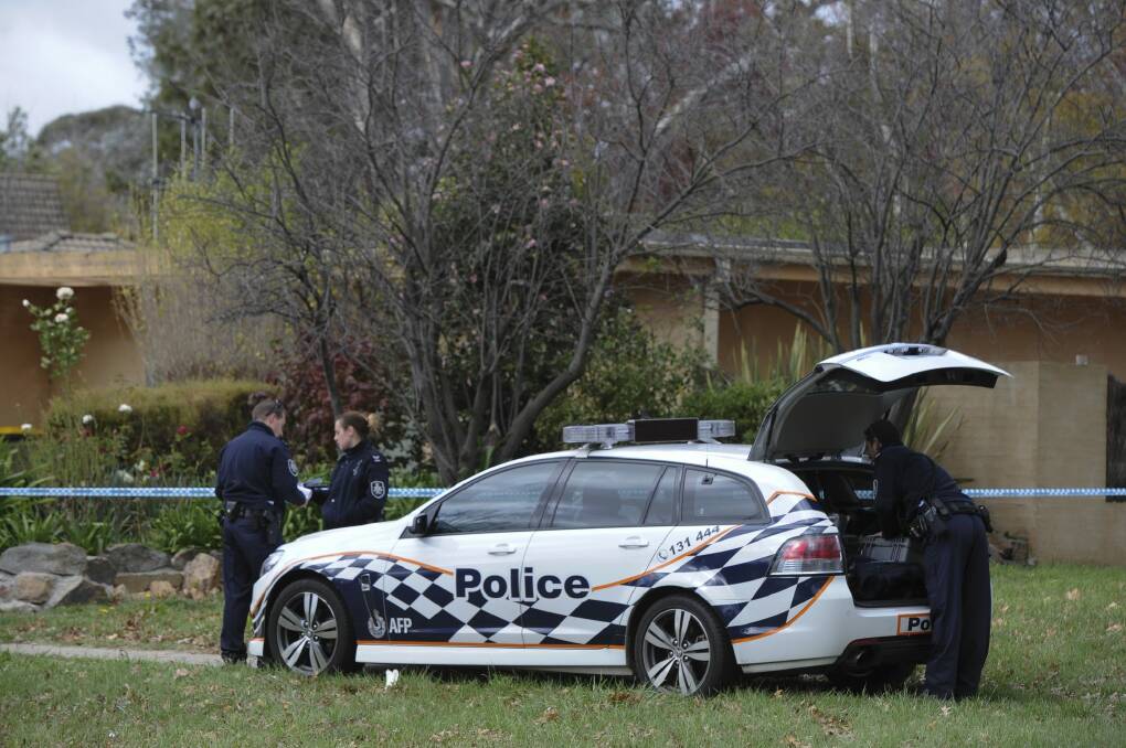 Police investigate an incident at La Perouse Street, Red Hill.
 Photo: Graham Tidy