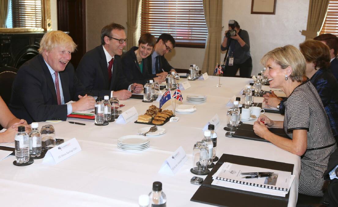British Foreign Secretary Boris Johnson, left, laughs along with Australian Foreign Minister Julie Bishop as they sit down to their bilateral meeting in Sydney on Wednesday. Photo: RICK RYCROFT