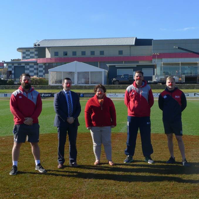Vikings player Liam McGrath, Vikings CEO Anthony Hill, Red Nose community fundraising coordinator Trudy Taylor, Vikings head coach Tim Sampson and Vikings player Fred Dorrough on the red nose on Viking Park oval at Erindale. Photo: Supplied