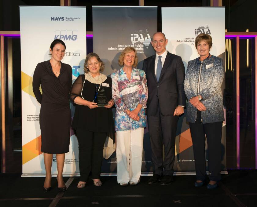 The 2015 gold winners of the Prime Minister's awards for excellence in public sector management: staff from the Tasmanian Education Department with federal Human Services Minister Stuart Robert and the Institute of Public Administration Australia's ACT president, Glenys Beauchamp. Photo: Rob Little