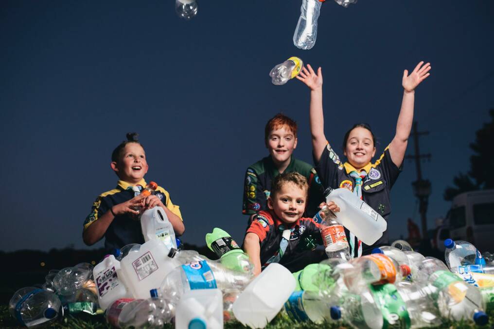 Lake Ginninderra scouts Eli Georgiou, 8, Adrian Lehane, 12, Oliver Georgiou, 6, and Bridget Lehane, 10, with a pile of bottles and cans. Groups like the scouts would benefit from the introduction of an ACT container deposit scheme. Photo: Rohan Thomson