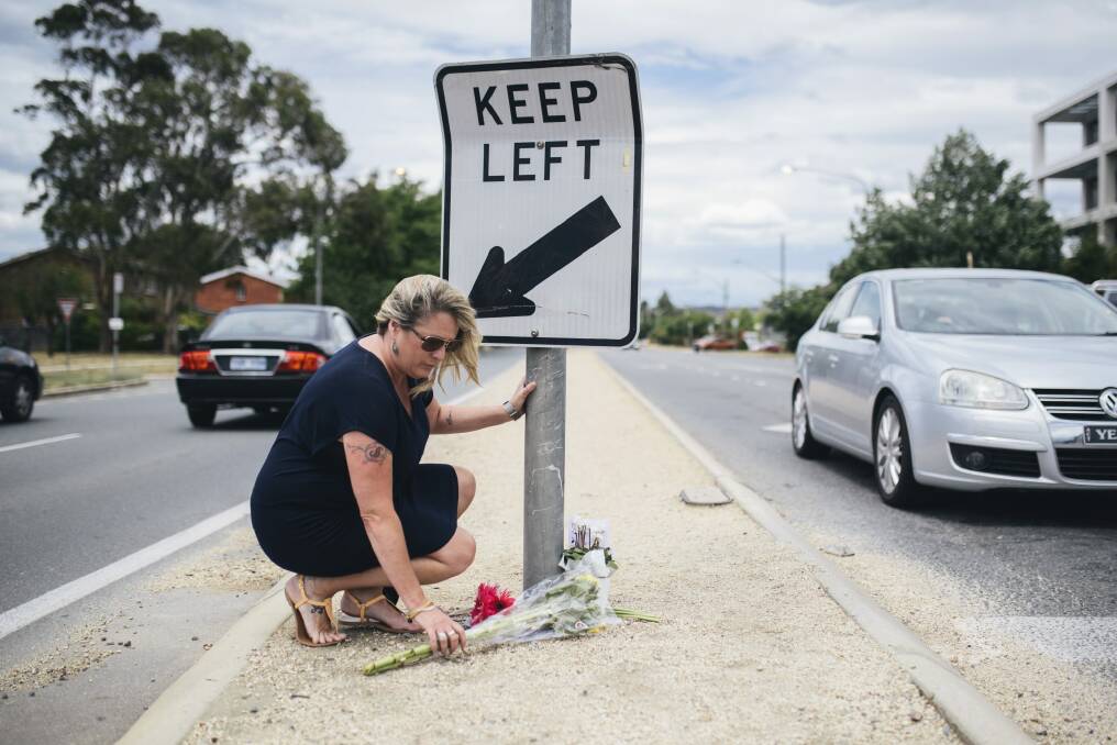 Flowers have been left at Ian 'Scrubby' Stokes' spot at the Northbourne/Antill intersection where he washed windscreens for many years.  Photo: Rohan Thomson