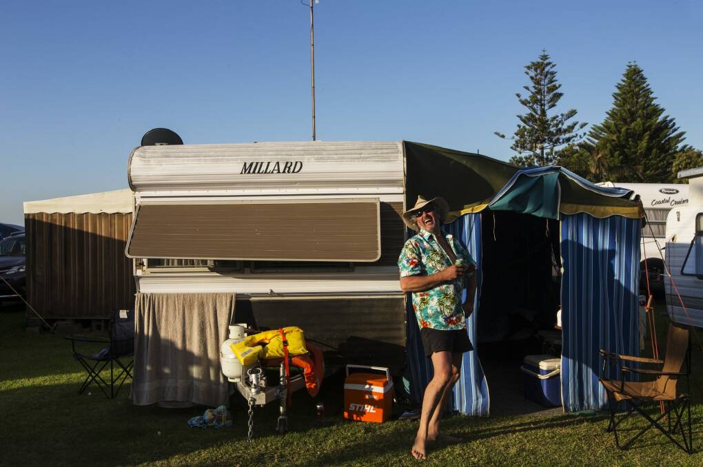 Tim Bennett  outside his family camper van at Two Shores Holiday Village at The Entrance. Photo: Nic Walker