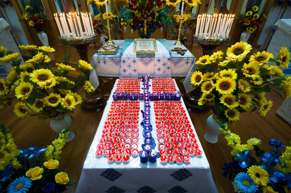 A candle was lit for each of the victims, with the cross representing the Australians killed. Photo: Dion Georgopoulos