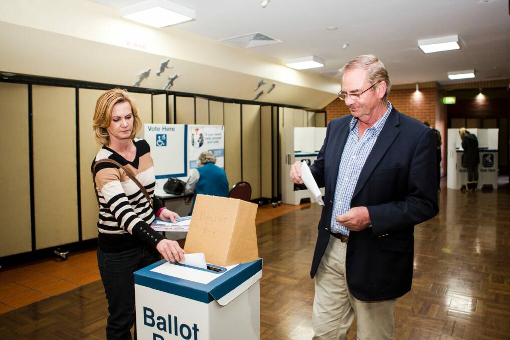Queanbeyan-Palerang Regional Council administrator Tim Overall, and his wife Nicole submit their vote on election day. Photo: Jamila Toderas