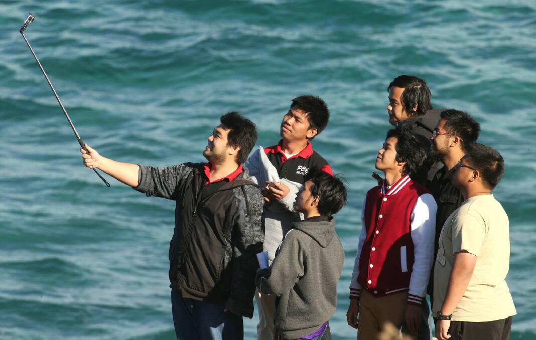 Must see: The selfie stick is becoming an essential for all tourists. Photo: Kirk Gilmour