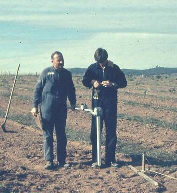 Brian Dalziel and Joug Kvedaras use a metal detector to find bombs in Tuggeranong in 1973.