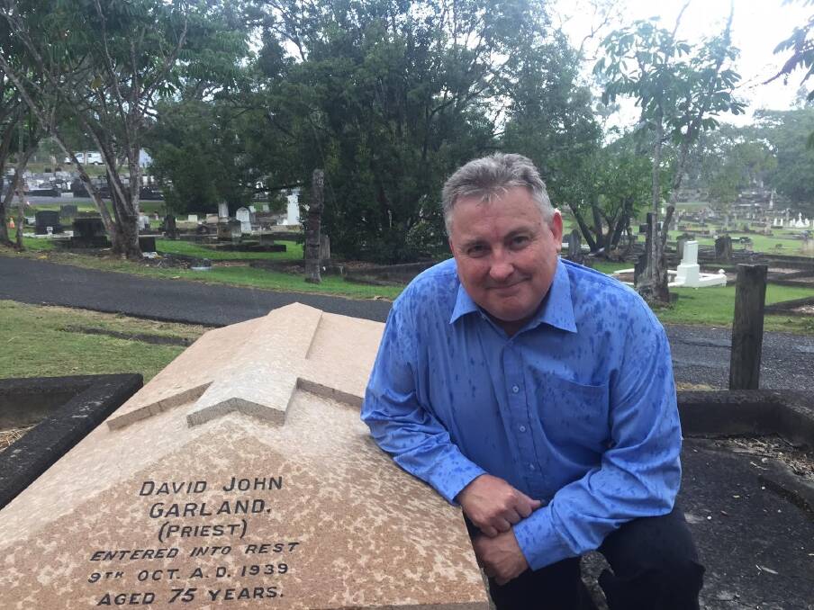 Historian Peter Collins at Canon Garland's grave at Toowong Cemetery. Photo: Tony Moore