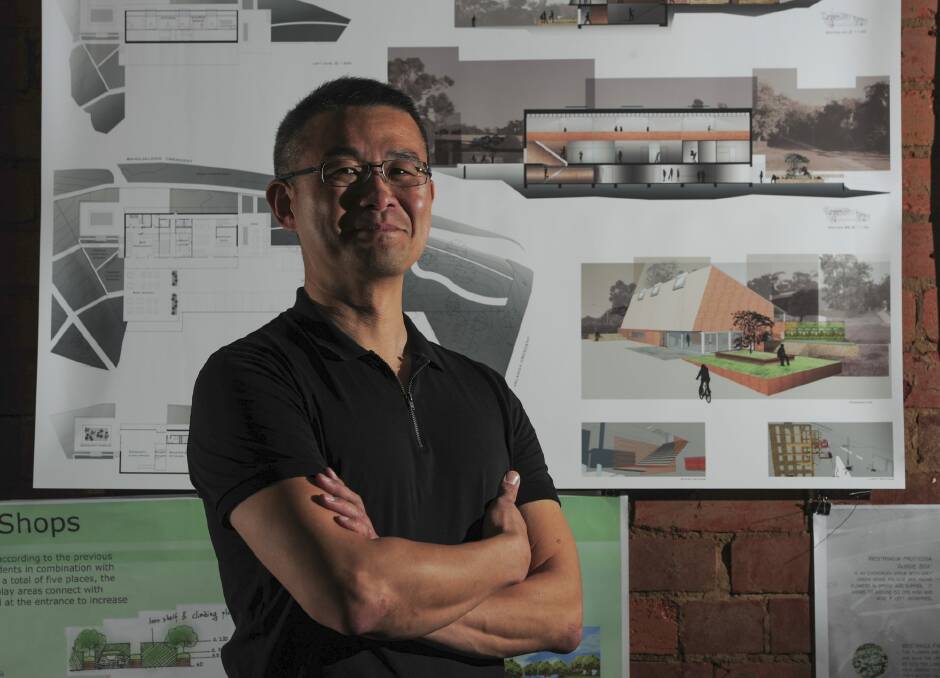 University of Canberra architecture student Cornelius Pau, of Dunlop, stands before his design. Photo: Graham Tidy