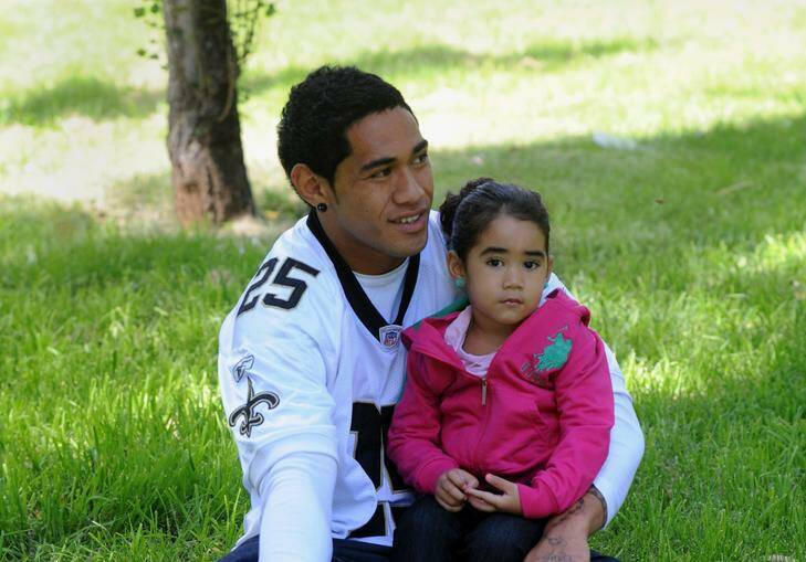 Brumbies player Joe Tomane relaxes in Telopea Park with his daughter,  three-year-old Starsha. Photo: Richard Briggs