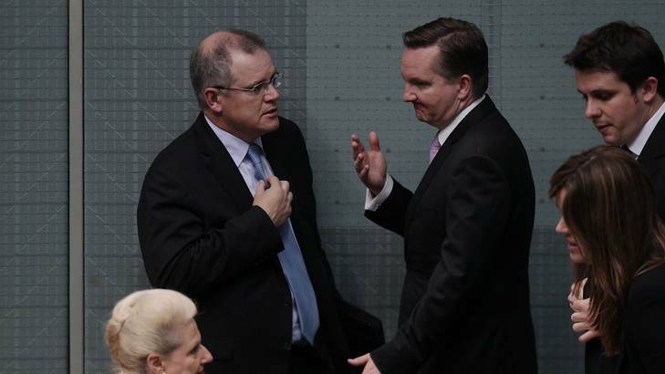 Shadow Immigration Minister Scott Morrison speaks with Immigration Minister Chris Bowen at the end of Question Time at Parliament House yesterday. Photo: Alex Ellinghausen/Fairfax