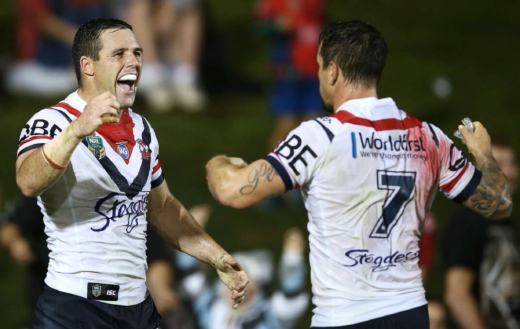 Centre of the action: Gordon celebrates his late try with Mitchell Pearce. Photo: Getty Images