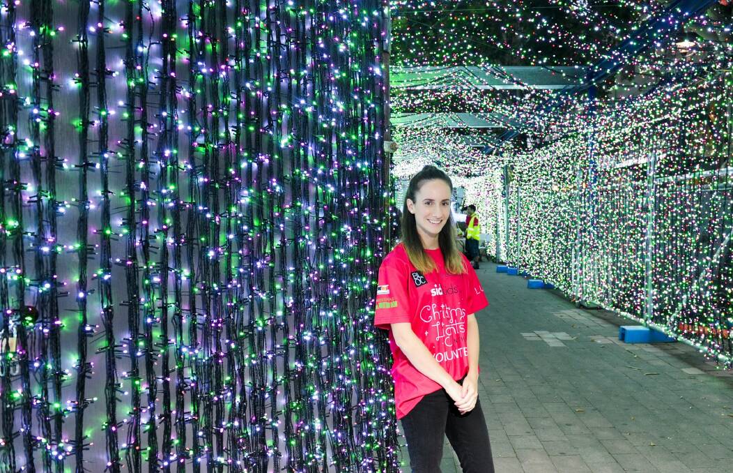 SIDS and Kids head volunteer Gabrielle Weidner, surrounded by Christmas lights in the city. Photo: Melissa Adams