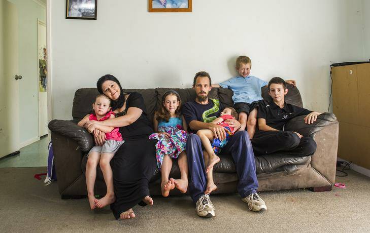 The Lovelock family (from left) Breannah, Melissa, Felicity, Terry, Brian, Nicholas, and Terry Jr., at their public housing home in Oxley. Photo: Rohan Thomson