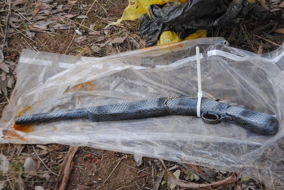 A shotgun was found wrapped in a plastic bag and buried at Kambah on Sunday. Photo: ACT Policing