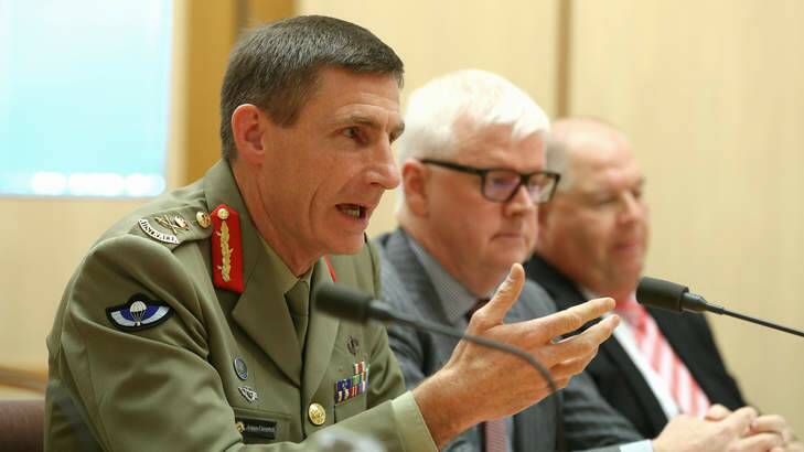 Operation Sovereign Borders chief Lieutenant-General Angus Campbell, doing the job of a minister. Photo: Alex Ellinghausen
