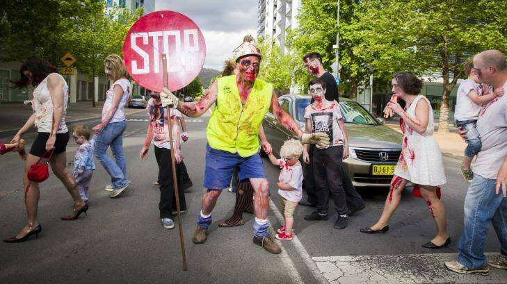  Dead stop: Paul McKie of Downer stops traffic for his fellow zombies in Civic during the annual Canberra Zombie Walk. Photo: Matt Bedford
