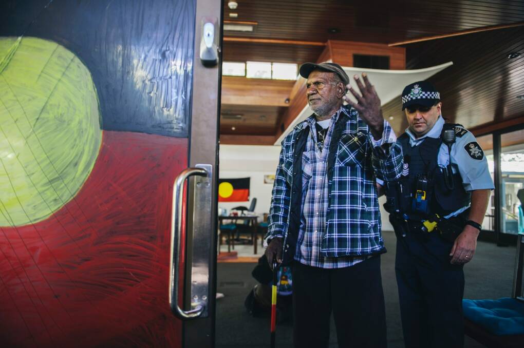 Activist Kevin Buzzacott with police. Photo: Rohan Thomson