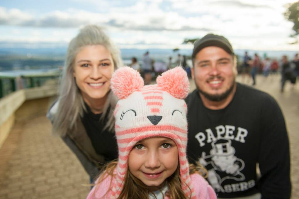 Jack Bush, Tayla Morris and Miah Newton, 5, up on Mount Ainslie finding a prime spot to watch the fireworks. Photo: Jay Cronan