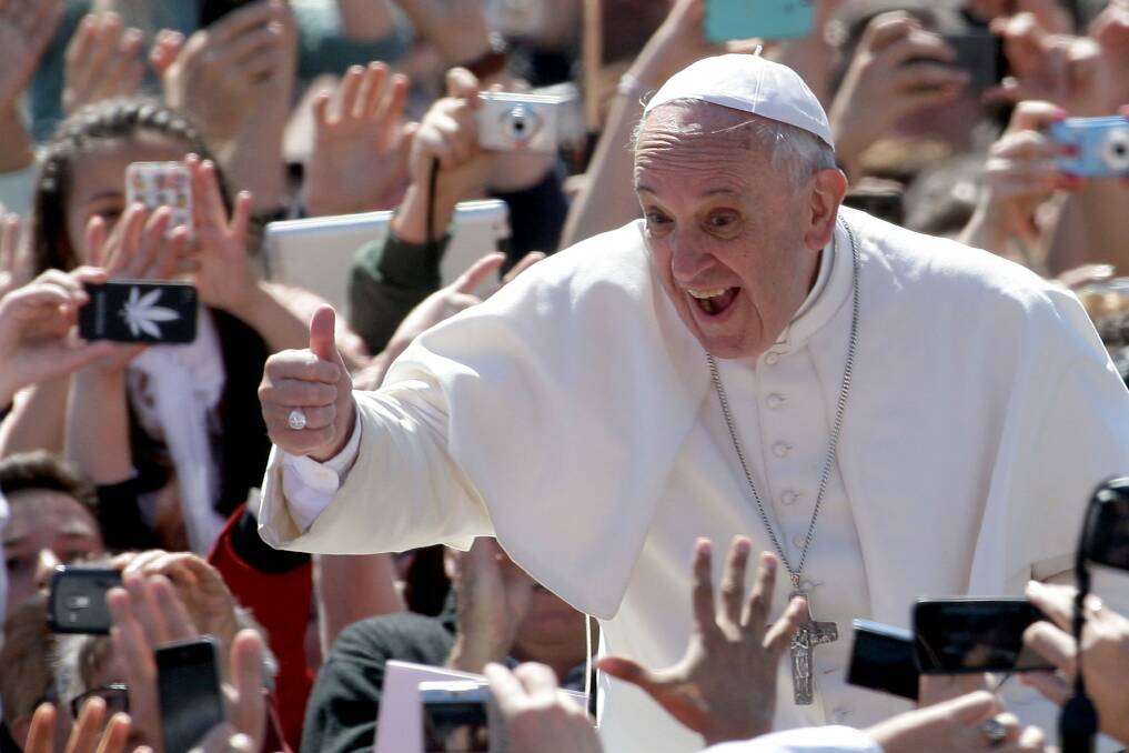 Pope Francis greets the faithful gathered for a Mass in St Peter's Square in the Vatican City with an enthusiastic thumbs up. Photo: Franco Origlia