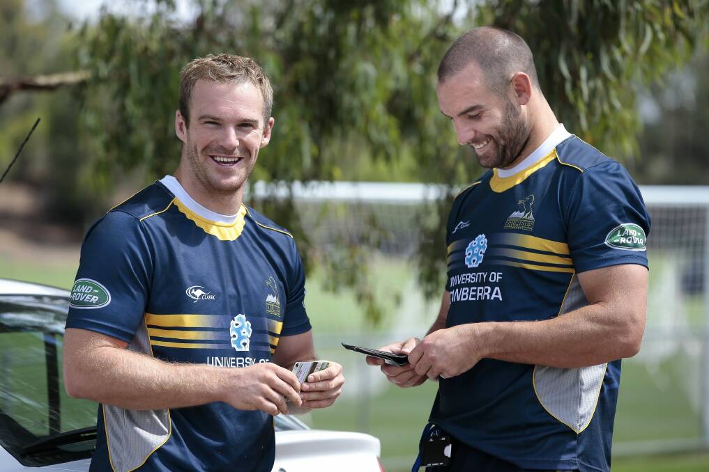 Buddies: ACT Brumbies players Pat McCabe and Scott Fardy share a laugh following a training session in 2014. Photo: Jeffrey Chan