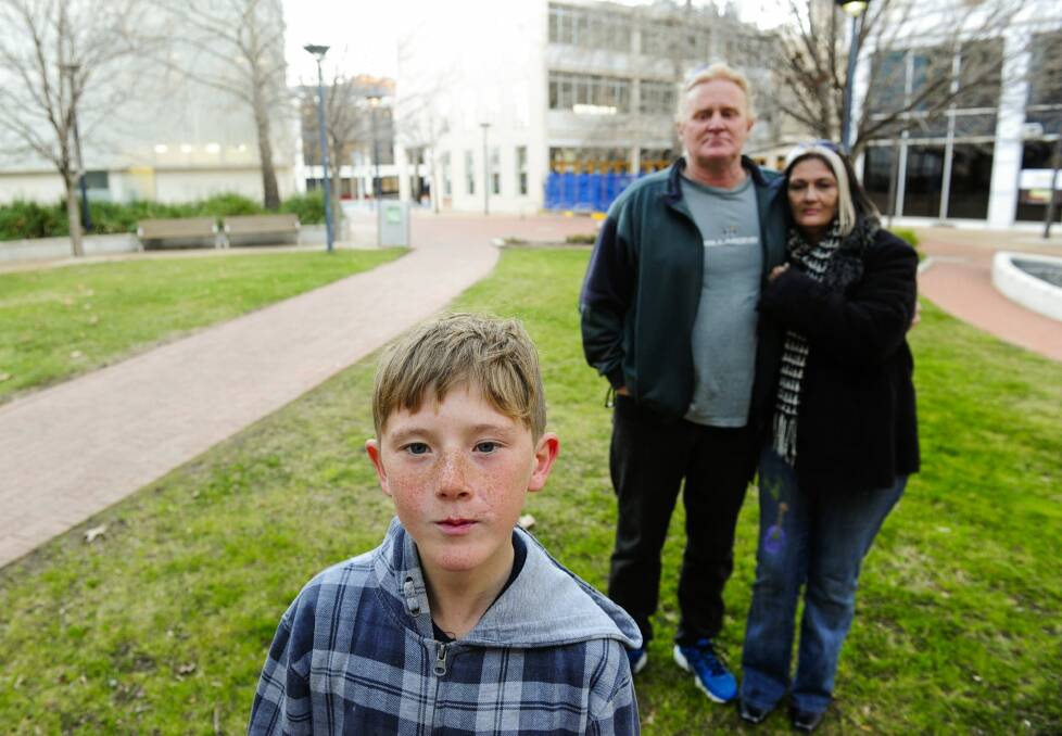 Patrick Hartigan and Joanne Mangan with their son Jack Hartigan aged 11 who has filed civil action against the ACT Government after he was mauled by dogs at a Housing ACT property. Photo: Melissa Adams