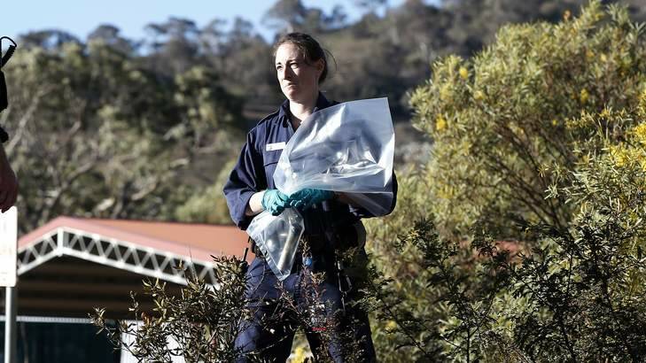 ACT Policing and Forensics members gathers evidence at a second site following a suspected pipe bomb being discharged. Photo: Jeffrey Chan