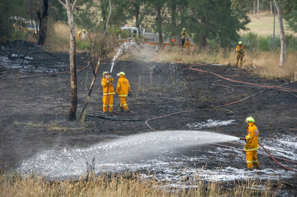 Emergency services attend a small grass fire in Umbagong District Park in Latham. Photo: Jay Cronan