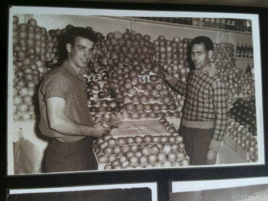 Gino Polimeni's father Luigi (left) and brother-in-law Charlie Cutri (right) in their Sydney fruit shop.
 Photo: Supplied