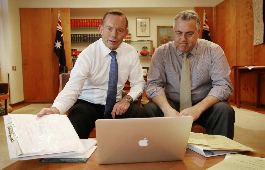 Prime Minister Tony Abbott poses with the Treasurer Joe Hockey as they look through budget papers. Photo: Andrew Meares