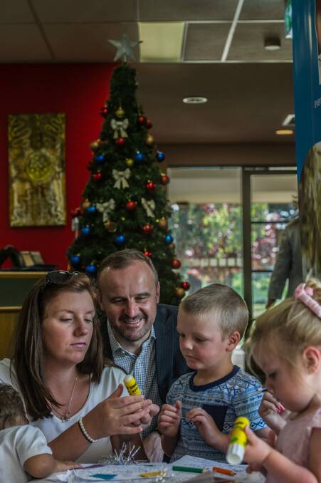 ACT Chief Minister Andrew Barr sits with the Smith Family donation recipients. Photo: Karleen Minney