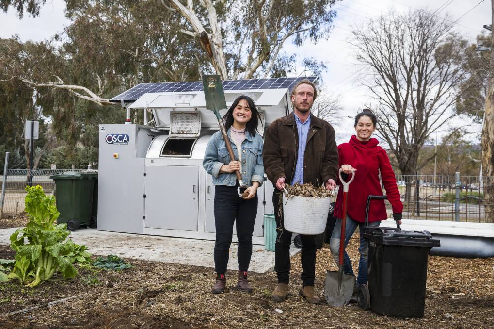 Events and projects manager Gaby Ho, director Ryan Lungu, garden coordinator Karina Bontes Forward next to their new public composter at the Canberra Environment Centre. Photo: Dion Georgopoulos