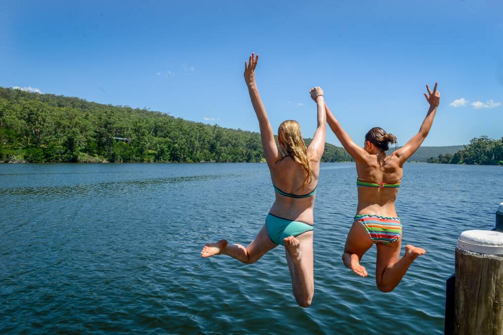 Girls jump into a secret swimming spot on the Shoalhaven River. Photo: Visit Shoalhaven 