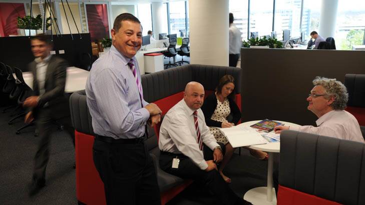 Managing Director ACT of Jones Lang LaSalle, Andrew Balzanelli, left, in the company's Civic office, with some of the staff. Photo: Graham Tidy