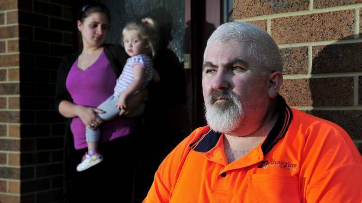 Michael Richer sits outside his house in Latham with his daughter Kylie Richer and granddaughter Sarah Watson. On Monday he lost his job at Douglas Quality Joinery. Photo: Jay Cronan