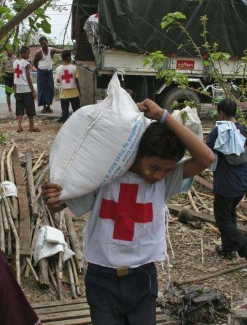 Myanmar Red Cross workers unload emergency food donations.
