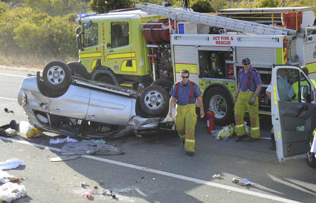 Emergency services access the scene of a single vehicle accident on the Federal Highway. Photo: Graham Tidy
