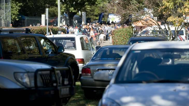 Cars parked on Manuka Circle as hoards of people enter the Giants game at Manuka Oval in April last year. Photo: Elesa Lee ELZ