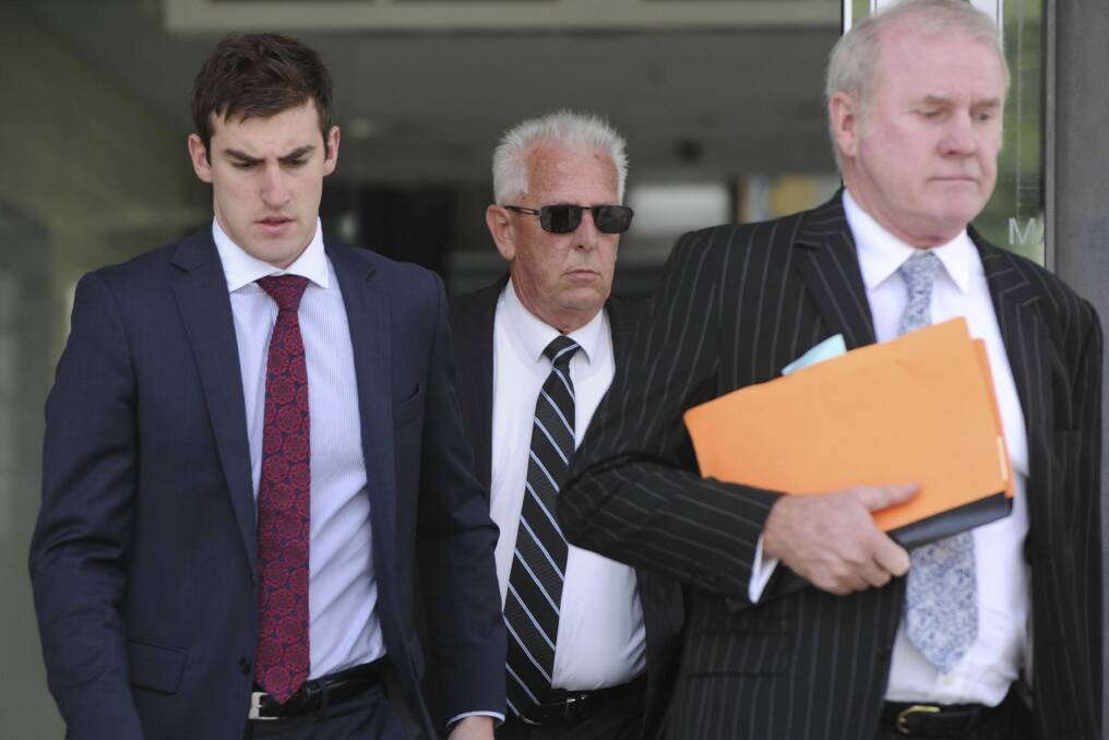 Peter Cuzner (middle) leaves the ACT Magistrates Court in February.  Photo: Graham Tidy